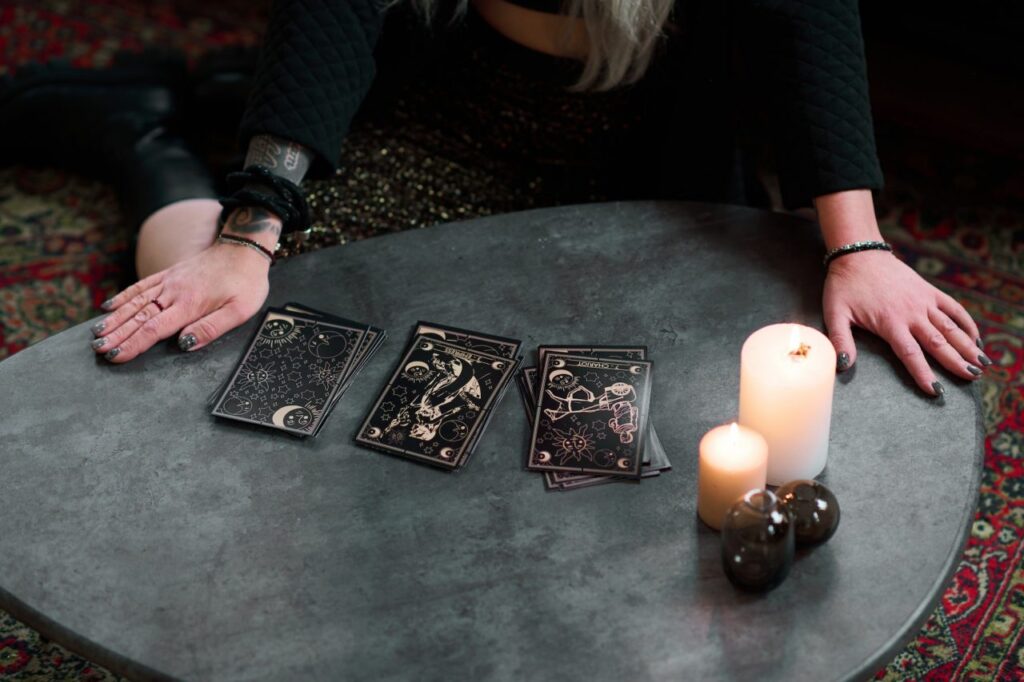 unrecognizable woman with tarot cards